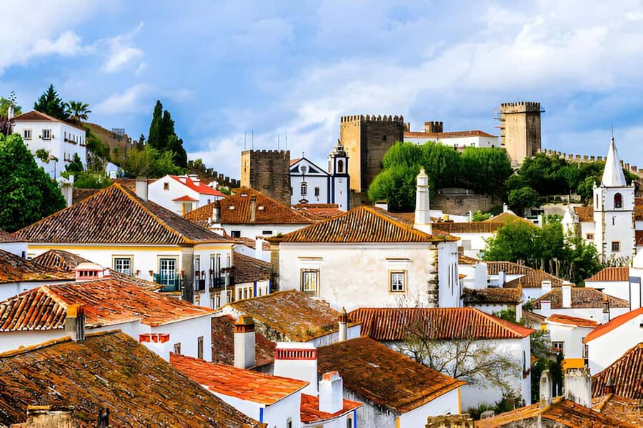 From Lisbon: Obidos, Nazaré and Fátima Small Group Tour - Óbidos castle walls, Santa Maria, and the ginjinha tradition