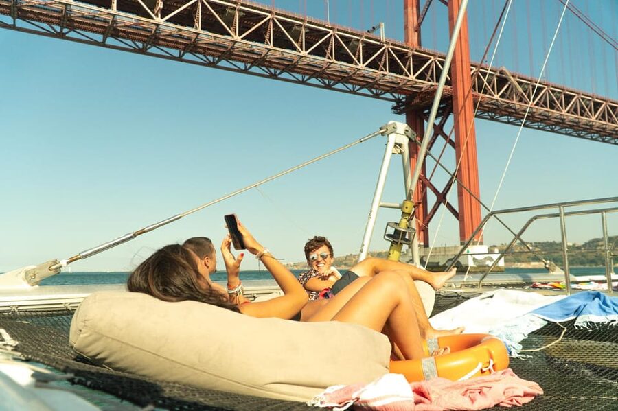 Lisbon: Catamaran Boat Party with Music, Open Bar & Dives - The cruise route: Algés, Belem Tower, and the 25 de Abril Bridge