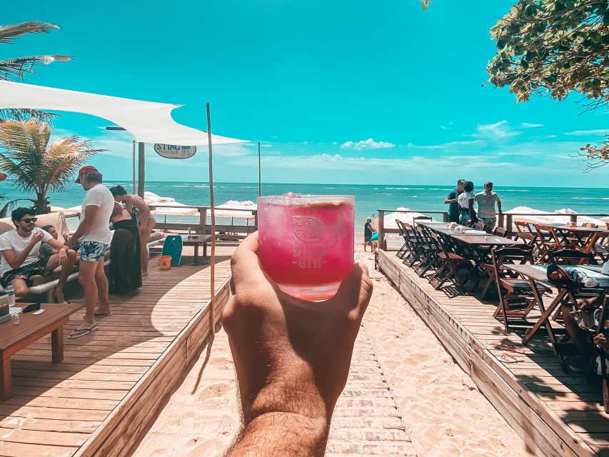 Lisbon Coast Tour: Paradise Beaches & Famous Beach Bars - Adraga Beach: cliff panoramas, lounge setup, and bubbles
