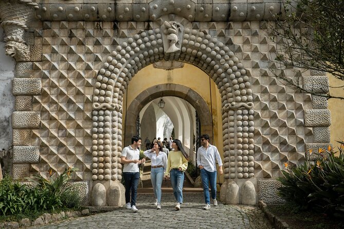 Sintra: Pena Palace & Cabo da Roca Hike from Lisbon - Praia da Adraga: rocky beach finale with caves and tunnels